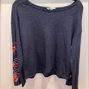 soft gray sweater, pink/red flowers on sleeves